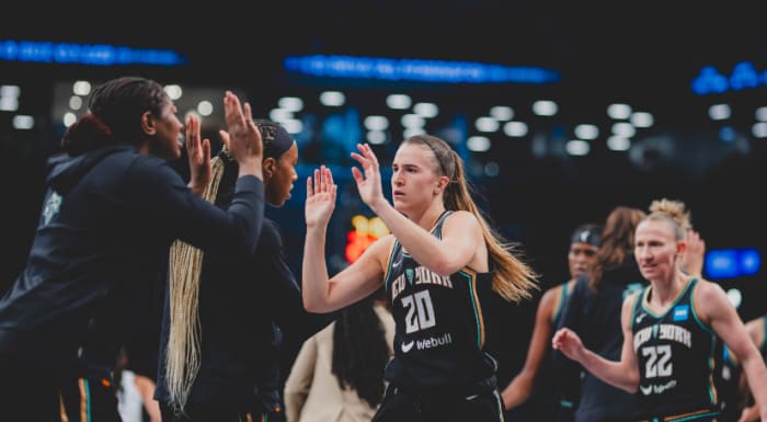 Ionescu (20) is greeted by Liberty teammates during a timeout in Game 3 action